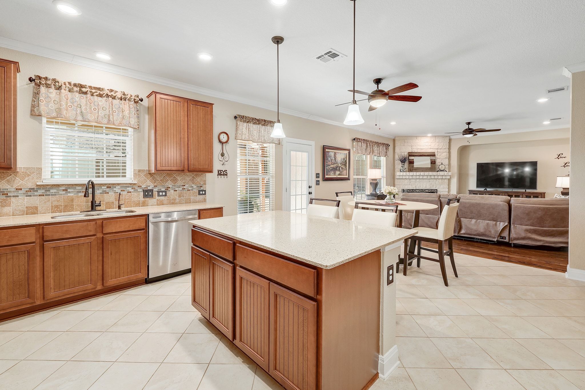 646 Landon Samuel Loop Pflugerville, TX 78660 - Photo 14 of 40 a kitchen with a sink counter top space appliances and a window