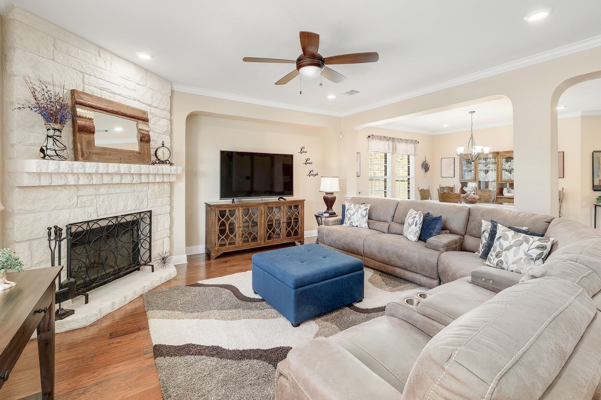 646 Landon Samuel Loop Pflugerville, TX 78660 - Photo 2 of 40 a living room with couches a fireplace and a flat screen tv