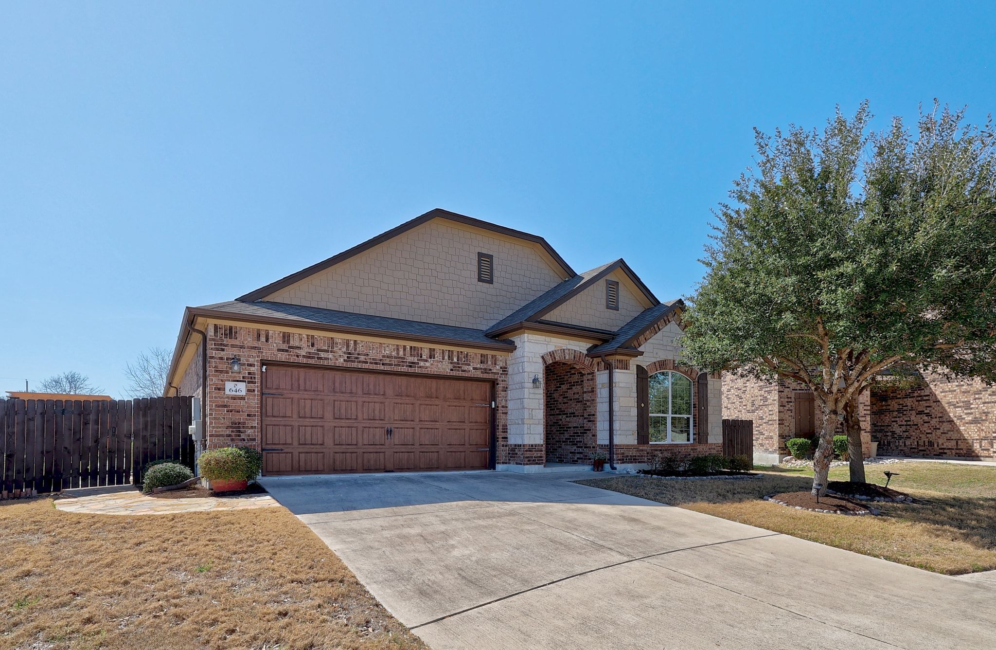 646 Landon Samuel Loop Pflugerville, TX 78660 - Photo 4 of 40 a front view of a house with a yard and garage