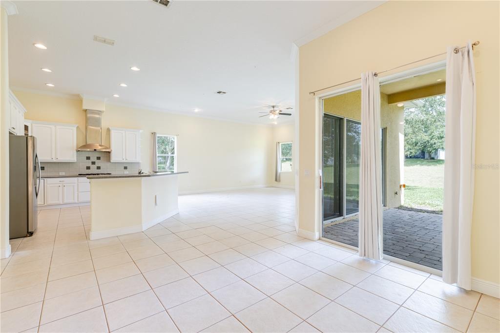 2718 Knightsbridge Road Clermont, FL 34711 - Photo 33 of 72 a large white kitchen with stainless steel appliances granite countertop a refrigerator and a sink