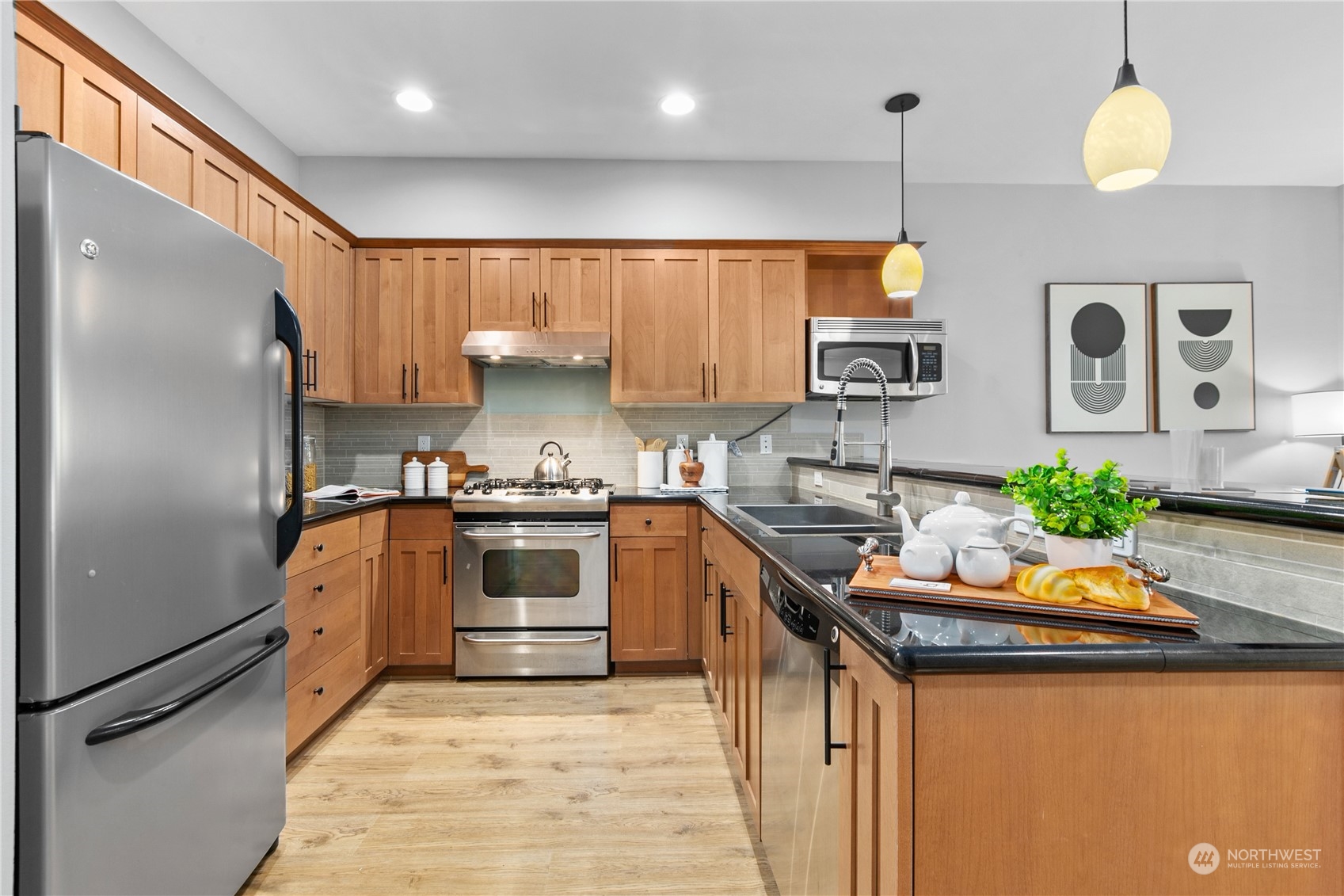 2115 201st Place Southeast, Unit D3 Bothell, WA 98012 - Photo 11 of 25 a kitchen with stainless steel appliances granite countertop a sink a stove and a refrigerator