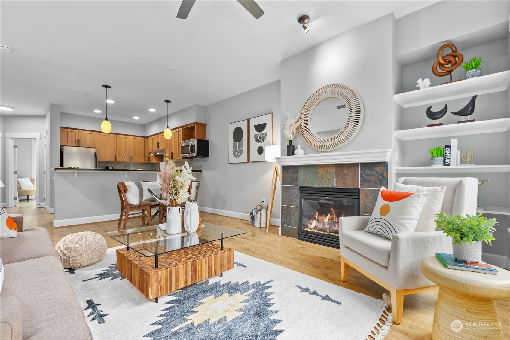 2115 201st Place Southeast, Unit D3 Bothell, WA 98012 - Photo 7 of 25 a living room with furniture a clock and a fireplace