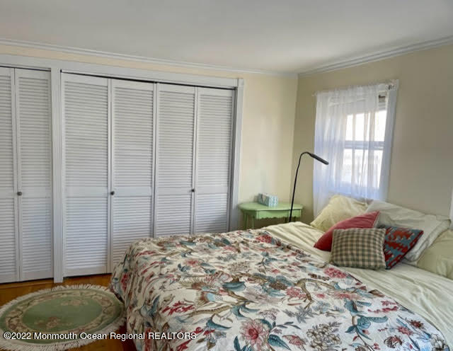 816 Atlantic Avenue, Unit A Point Pleasant, NJ 08742 - Photo 17 of 23 a bedroom with a bed and a window