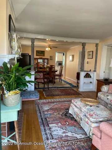 a living room with furniture and a dining table