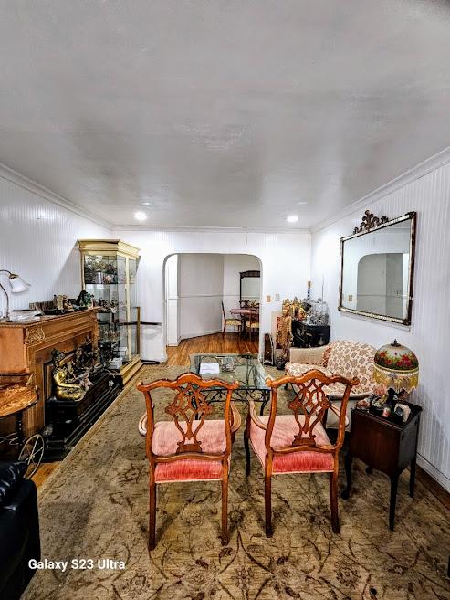 76-10 34th Avenue, Unit 2M Queens, NY 11372 - Photo 4 of 9 Living room featuring crown molding, arched walkways