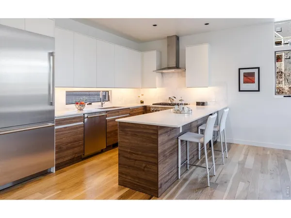 a kitchen with a wooden table and chairs