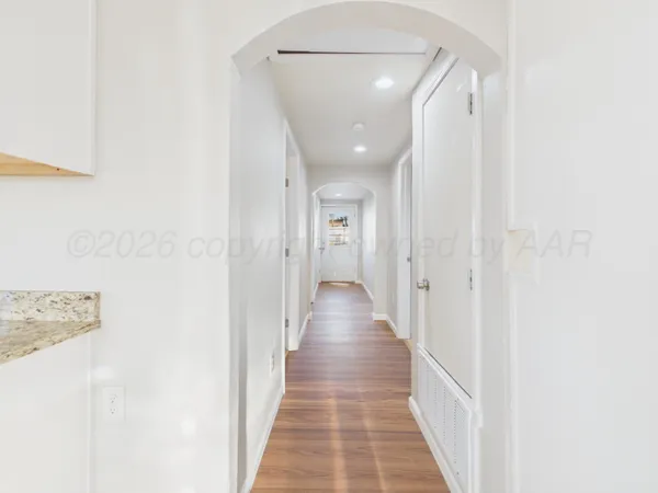 a view of a hallway with wooden floor
