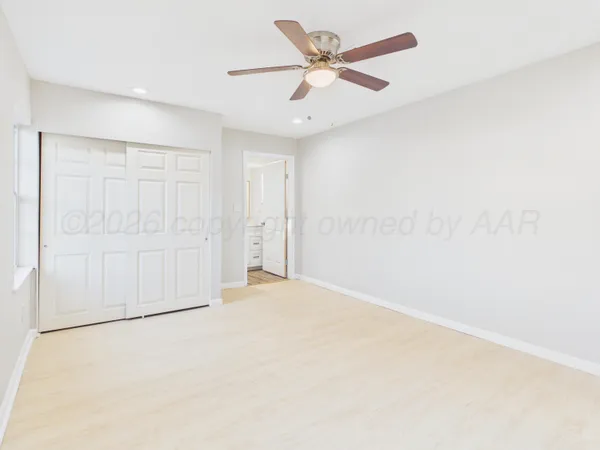 an empty room with a ceiling fan