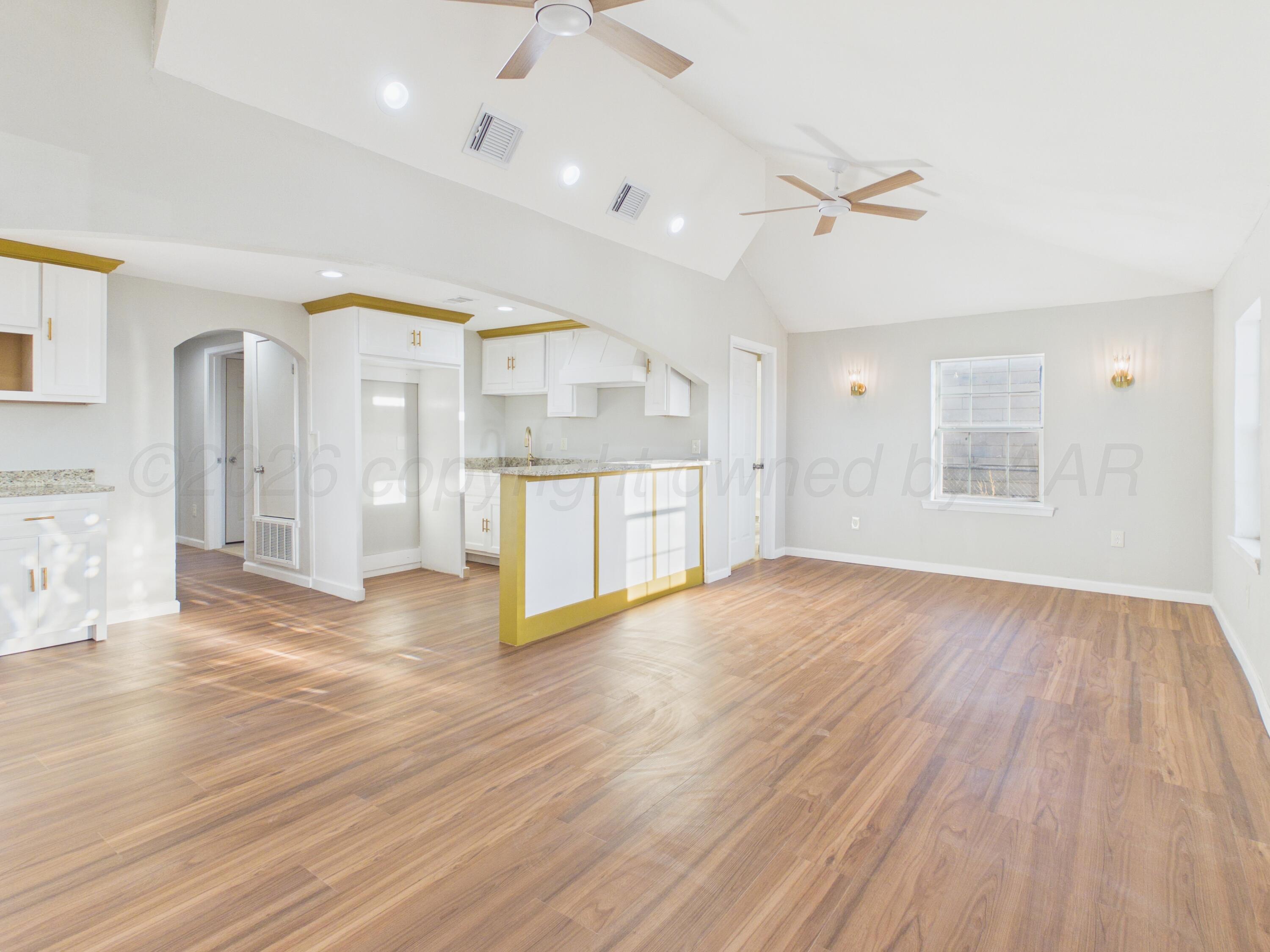 310 North Virginia Street Amarillo, TX 79106 - Photo 3 of 33 a view of an empty room with wooden floor and a window