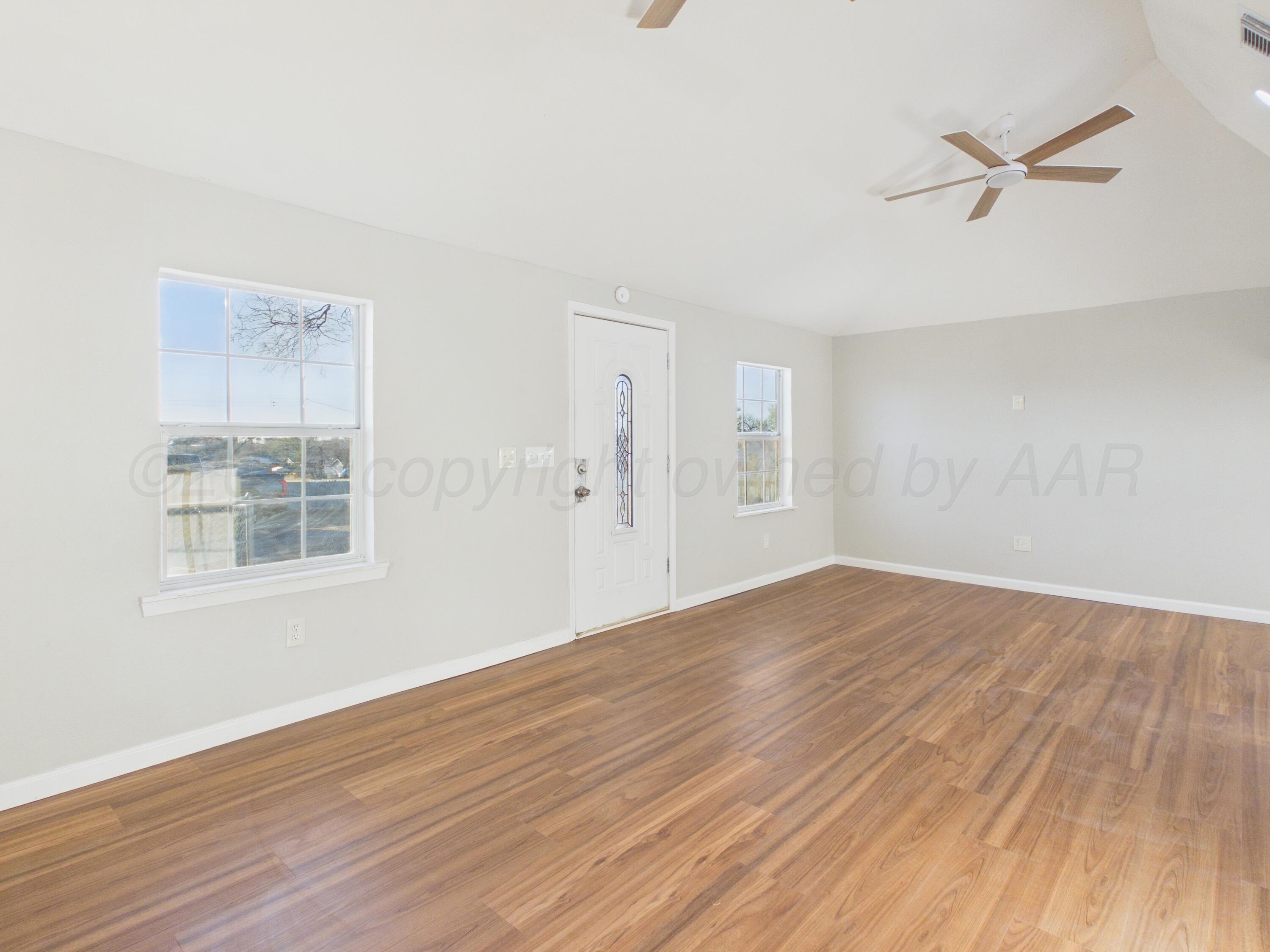 310 North Virginia Street Amarillo, TX 79106 - Photo 5 of 33 a view of empty room with wooden floor and fan