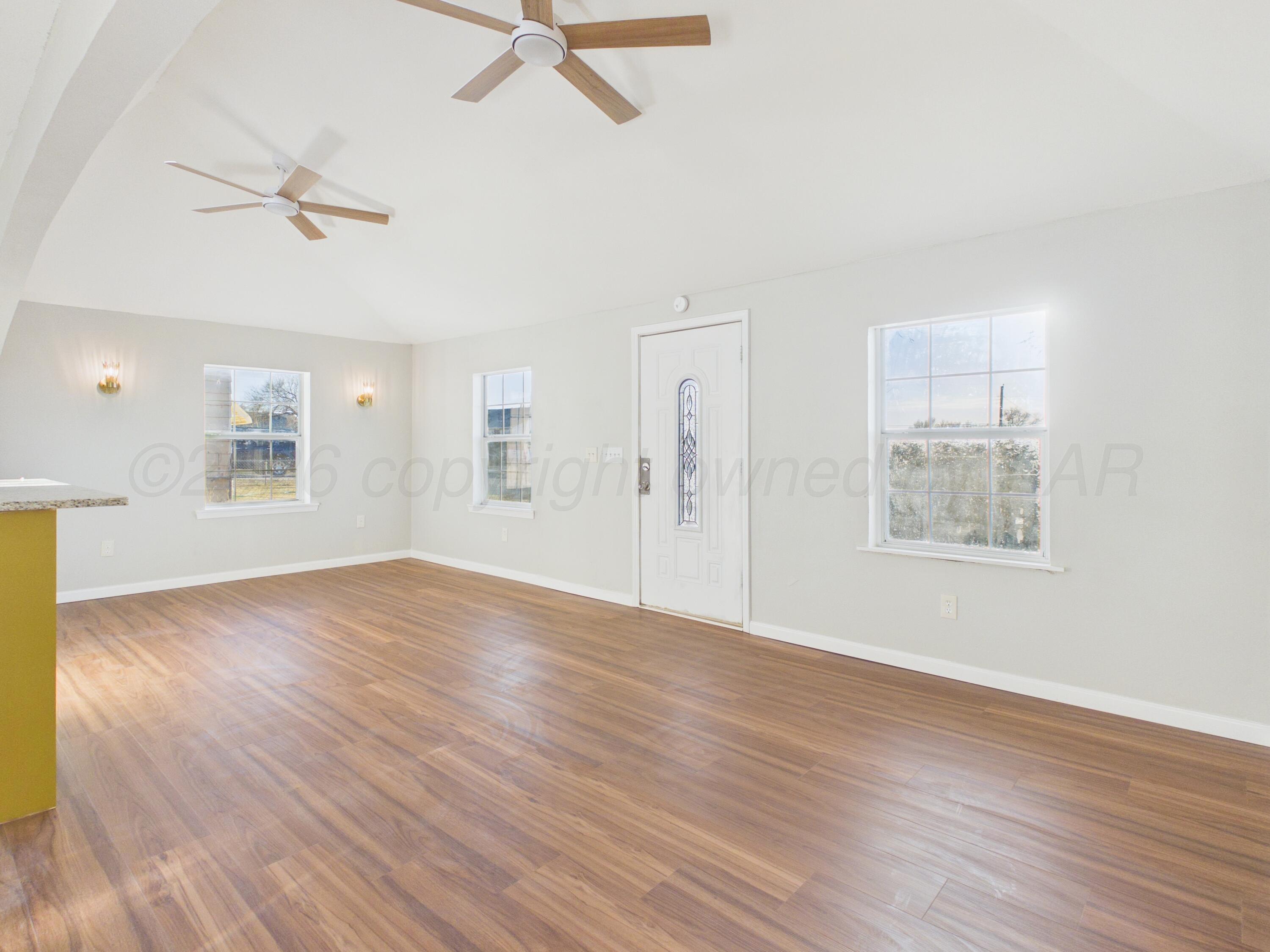 310 North Virginia Street Amarillo, TX 79106 - Photo 6 of 33 a view of an empty room with wooden floor and a window