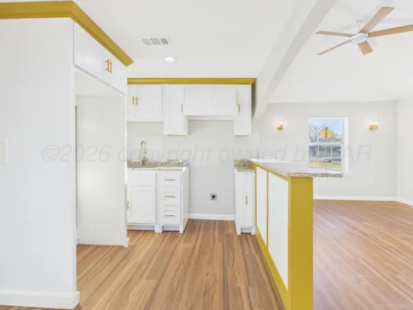 a view of a kitchen with wooden floor