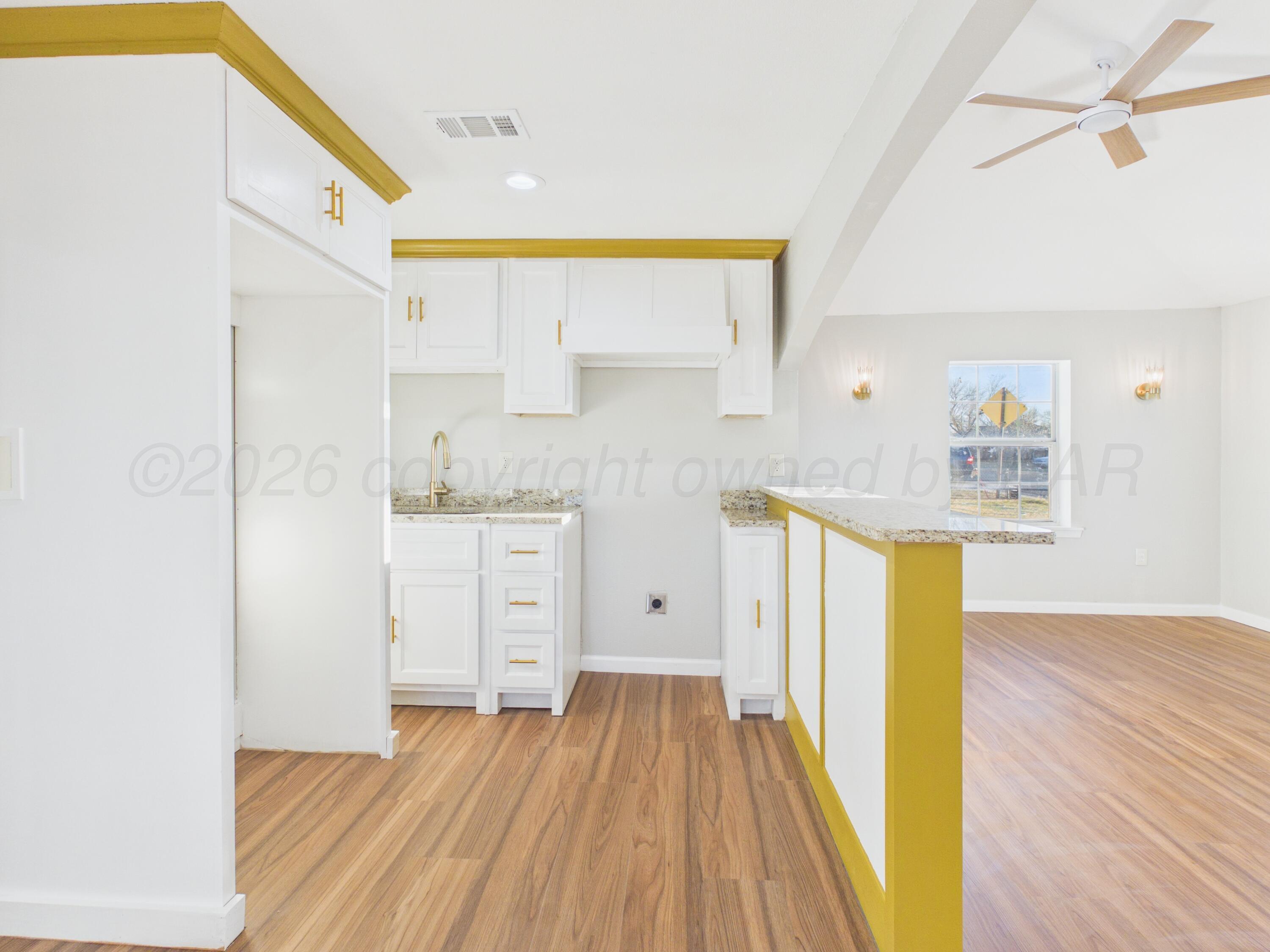 310 North Virginia Street Amarillo, TX 79106 - Photo 8 of 33 a view of a kitchen with wooden floor