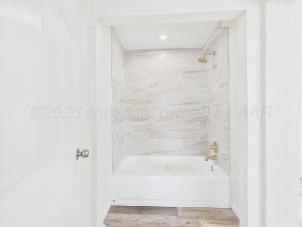 a bathroom with a bathtub and shower