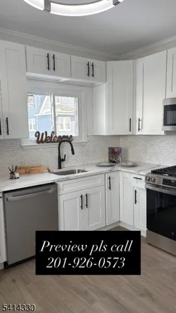a kitchen with a sink window and cabinets