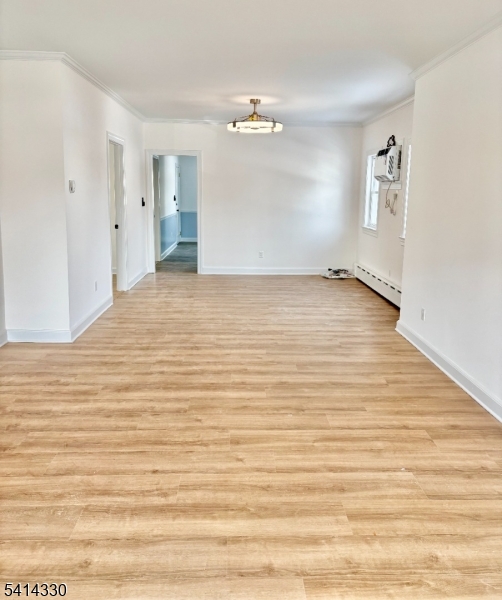 458 Totowa Road, Unit 3 Totowa, NJ 07512 - Photo 5 of 20 a view of a room with wooden floor and white walls