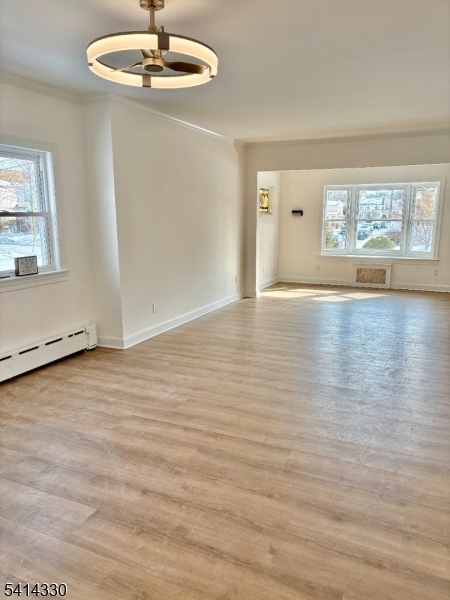 458 Totowa Road, Unit 3 Totowa, NJ 07512 - Photo 6 of 20 an empty room with wooden floor and windows