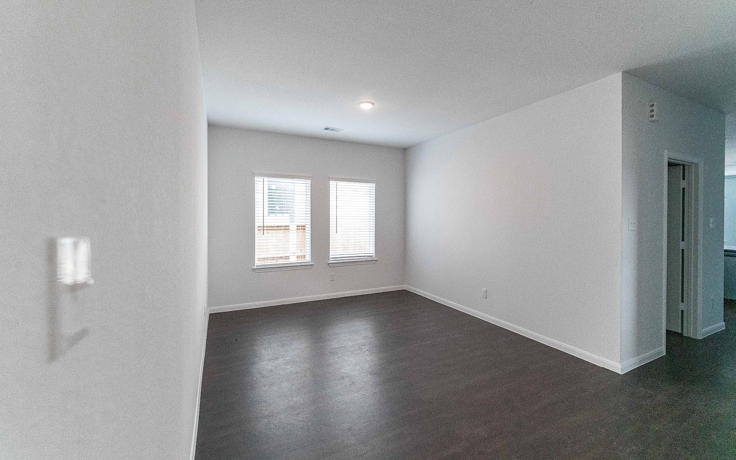 1718 Windrose Bend Angleton, TX 77515 - Photo 3 of 14 an empty room with wooden floor and windows