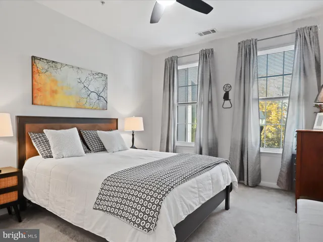 a bedroom with a large bed and a chandelier