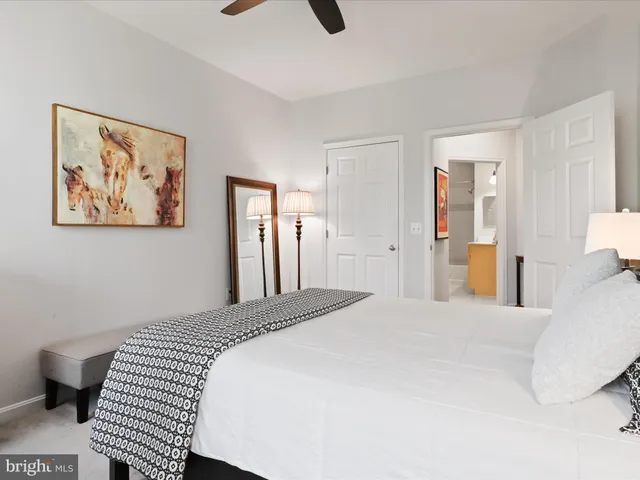 a bedroom with a large bed and a chandelier