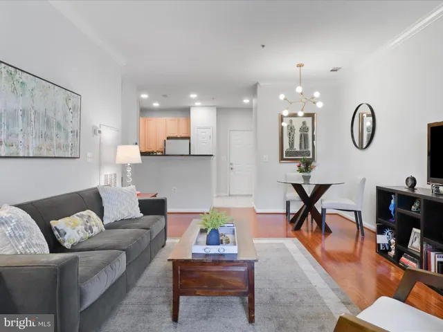 a living room with furniture and kitchen view