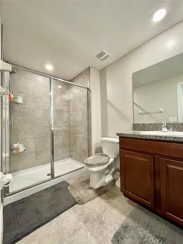 a bathroom with a shower and a toilet