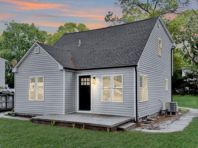 49 Heston Road Shirley, NY 11967 - Photo 1 of 1 Back of house at dusk featuring roof with shingles, a lawn, and a deck