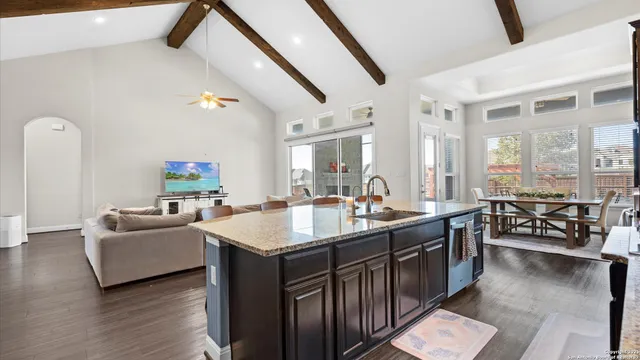 a kitchen with stainless steel appliances granite countertop a sink a stove and a refrigerator