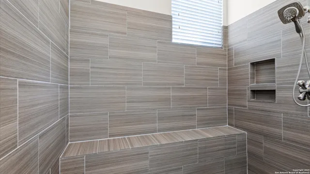 a bathroom with a tub and a window