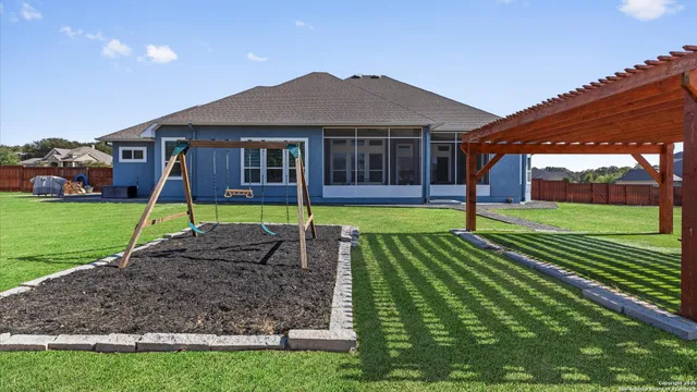 a view of a garden with a house in the background