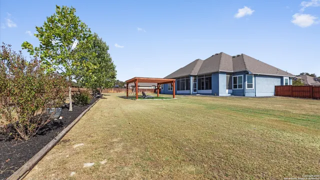 a view of a house with swimming pool and yard