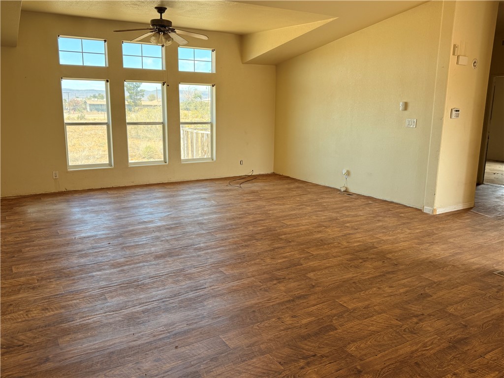 5495 Destiny Way Golden Valley, AZ 86413 - Photo 4 of 48 an empty room with wooden floor fan and windows