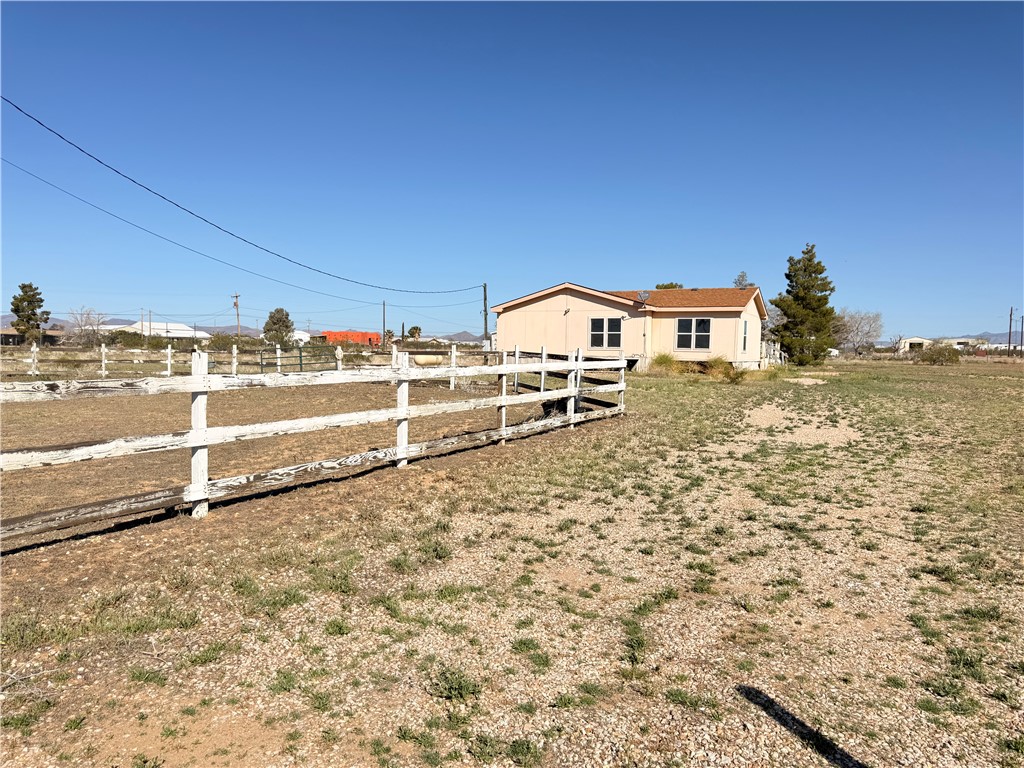5495 Destiny Way Golden Valley, AZ 86413 - Photo 41 of 48 a view of a wooden house with a yard