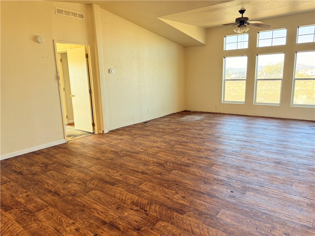5495 Destiny Way Golden Valley, AZ 86413 - Photo 5 of 48 an empty room with wooden floor and windows