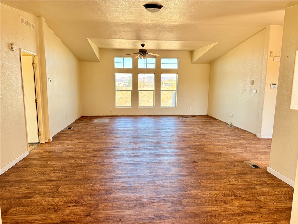 5495 Destiny Way Golden Valley, AZ 86413 - Photo 6 of 48 an empty room with wooden floor and windows