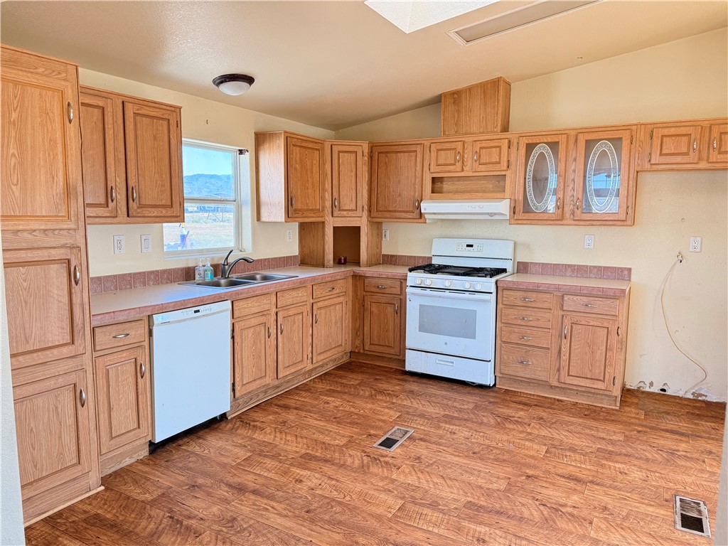 5495 Destiny Way Golden Valley, AZ 86413 - Photo 9 of 48 a kitchen with stainless steel appliances granite countertop a stove a sink and a microwave