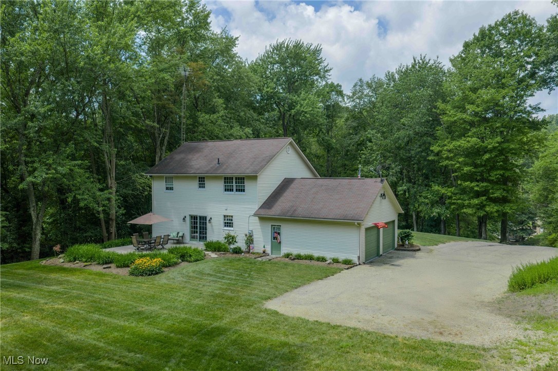 6535 Middle Run Road Dover, OH 44622 - Photo 26 of 40 Colonial house featuring driveway, an attached garage, and a front lawn