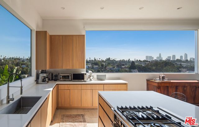 a large kitchen with a large window and a sink