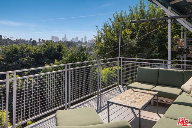 a balcony with wooden floor and fence