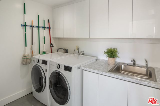 a utility room with sink dryer and washer