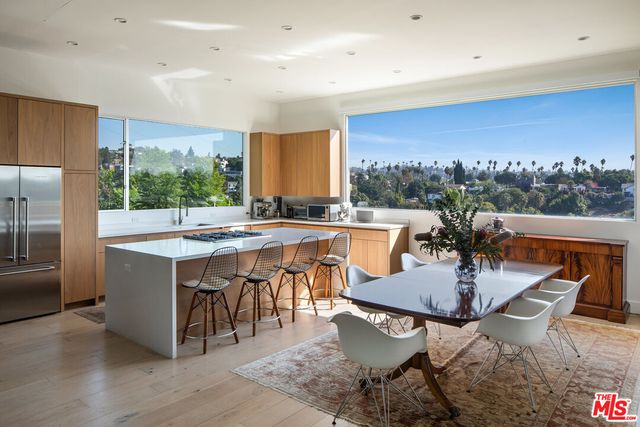 a large kitchen with a table and chairs