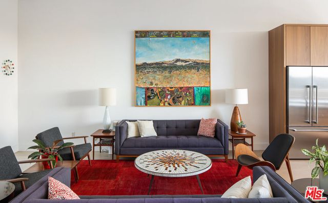 a living room with furniture a rug and a large window