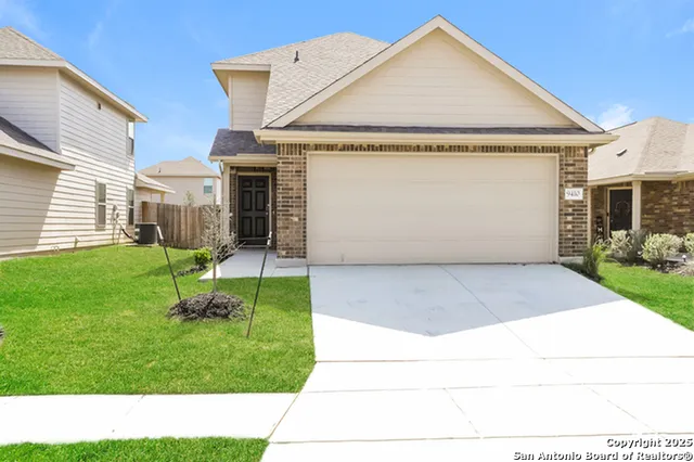 a view of a house with a yard and sitting area