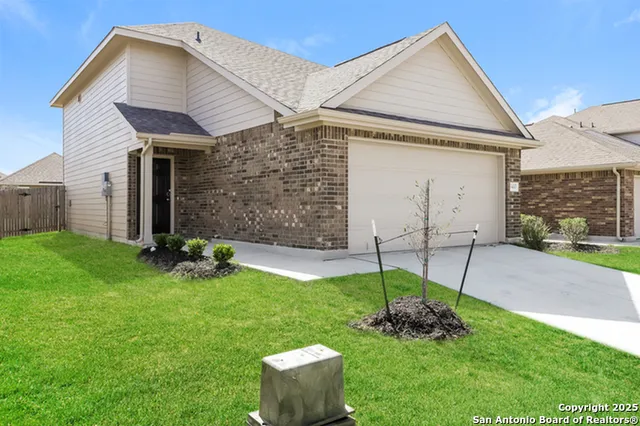a view of a house with a yard and sitting area