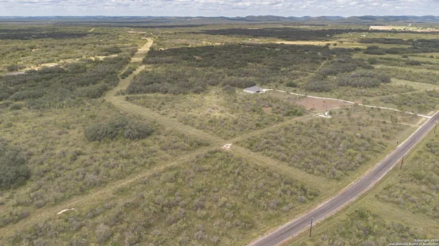 a view of a dry yard with wooden floor and a lake view