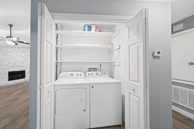 a view of washer and dryer with kitchen in the background