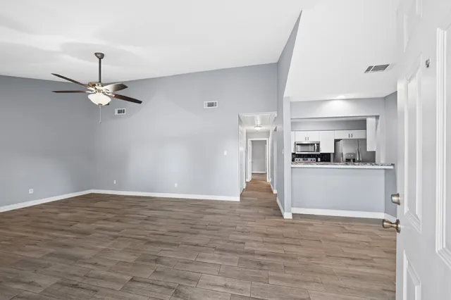 a view of a kitchen with a sink and a refrigerator