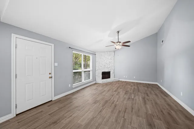 wooden floor in an empty room with a window