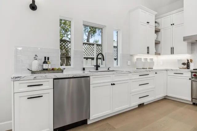 a kitchen with white cabinets and white appliances