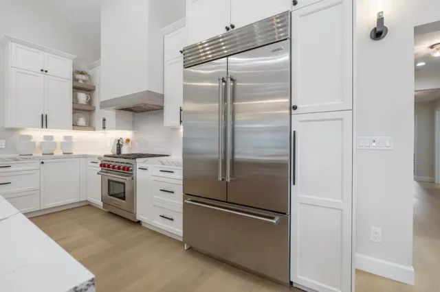 a large kitchen with a table and chairs